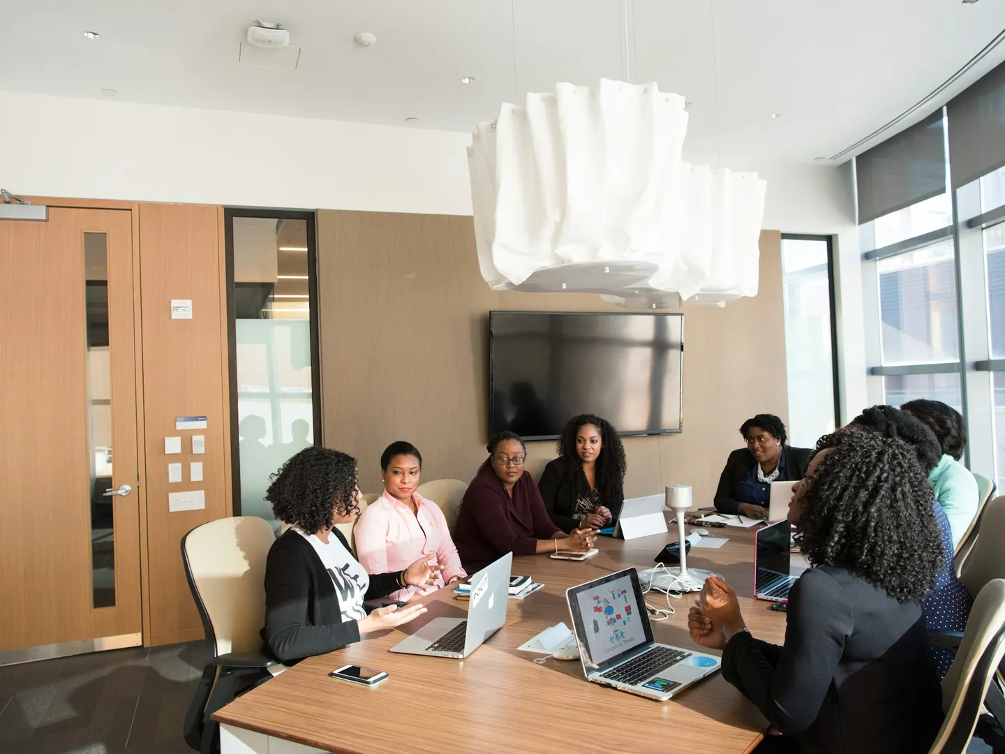 A team of professionals in a bright boardroom during a meeting